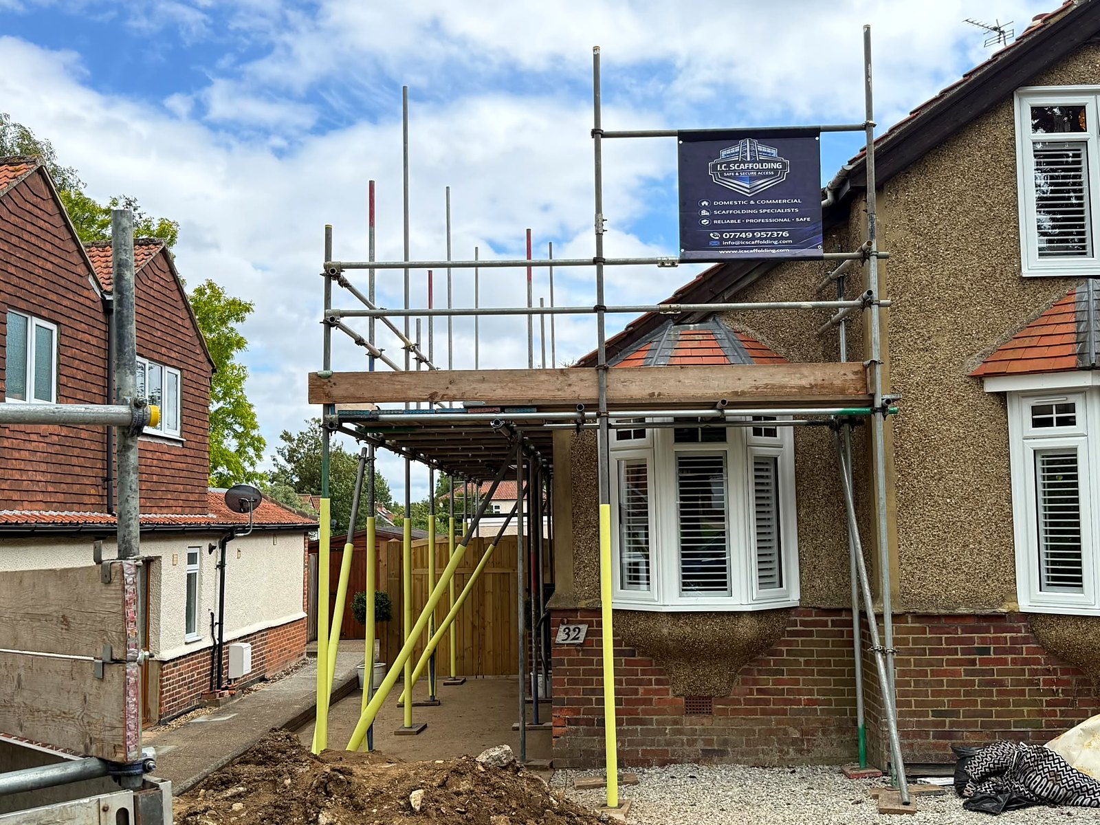 Compact access tower threaded up a tight side return between the house and the boundary fence